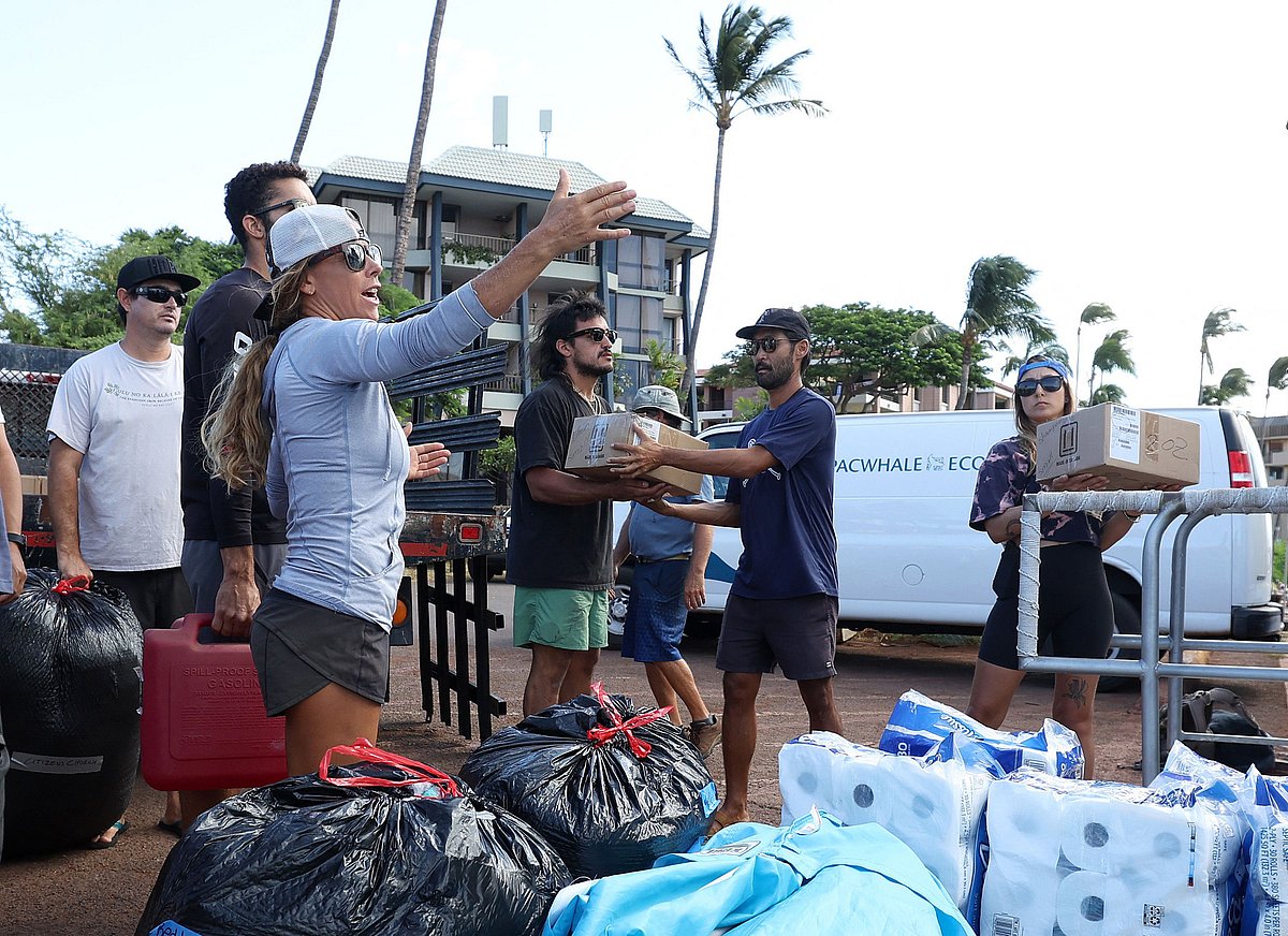 Volunteers load donated items onto a boat to be transported to Lahaina on August 12, 2023 in Wailuku, Hawaii