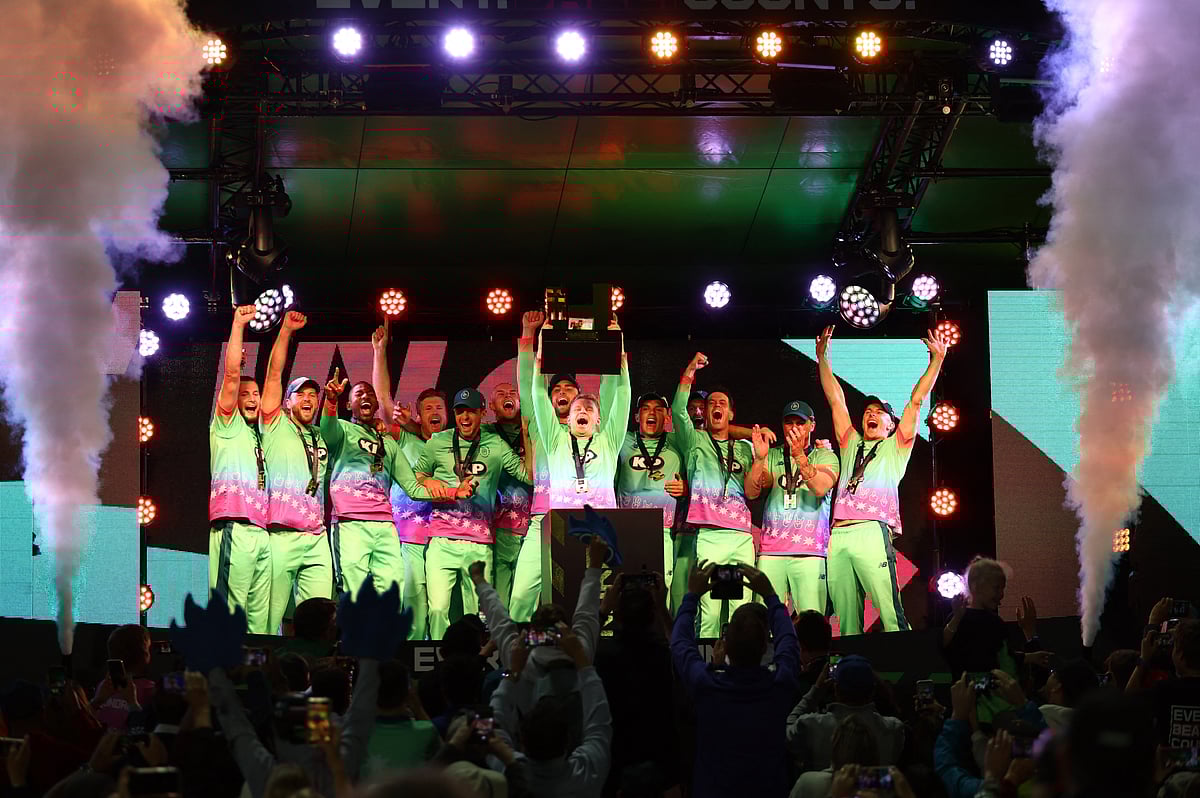 Oval Invincibles' Sam Curran celebrates with the trophy and teammates after winning the men's hundred final