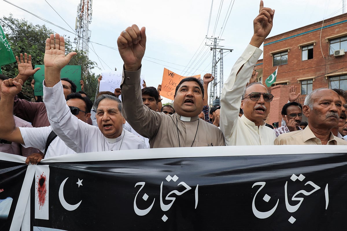 Members of the Christian community chant slogans as they hold banner to condemn the attacks on churches and houses in Jaranwala town of Faisalabad, during a protest in Peshawar, Pakistan August 17, 2023