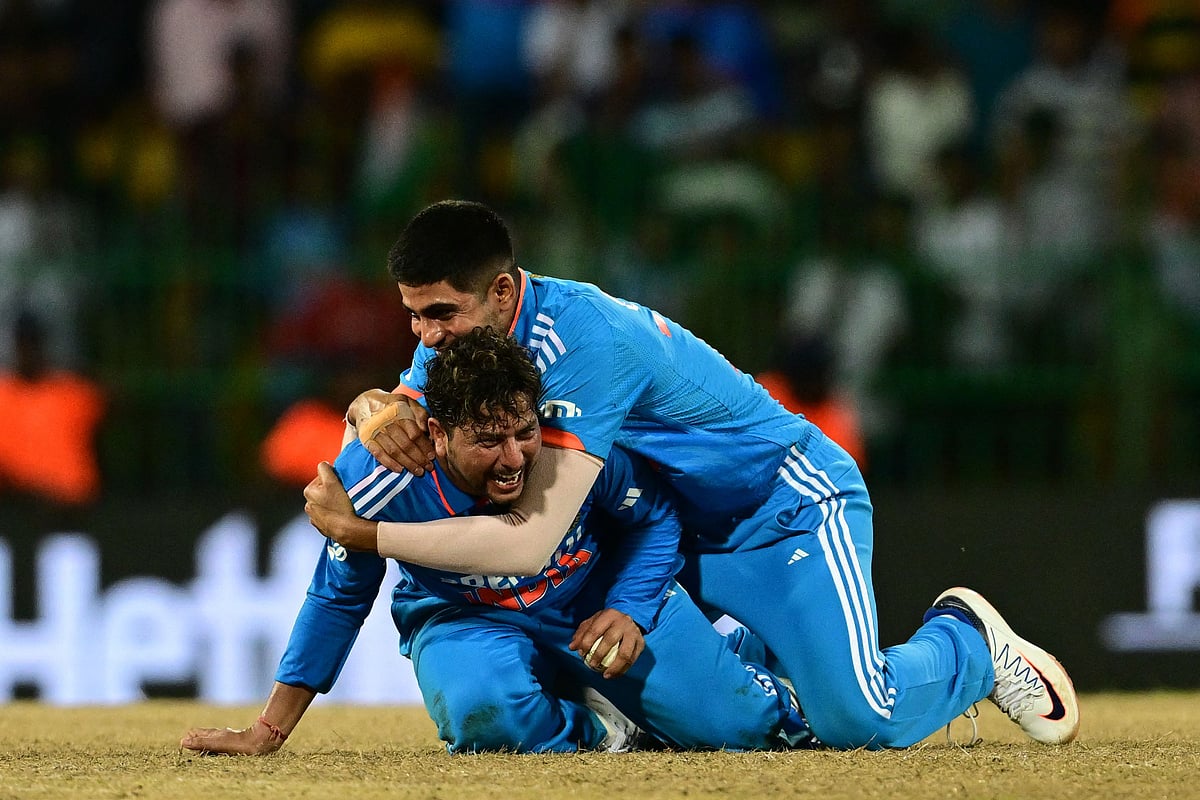 India's Kuldeep Yadav (L) and Shubman Gill celebrates after taking the wicket of Pakistan's Iftikhar Ahmed during the Asia Cup 2023 Super 4 match between India and Pakistan at the R. Premadasa Stadium in Colombo on 11 September 2023
