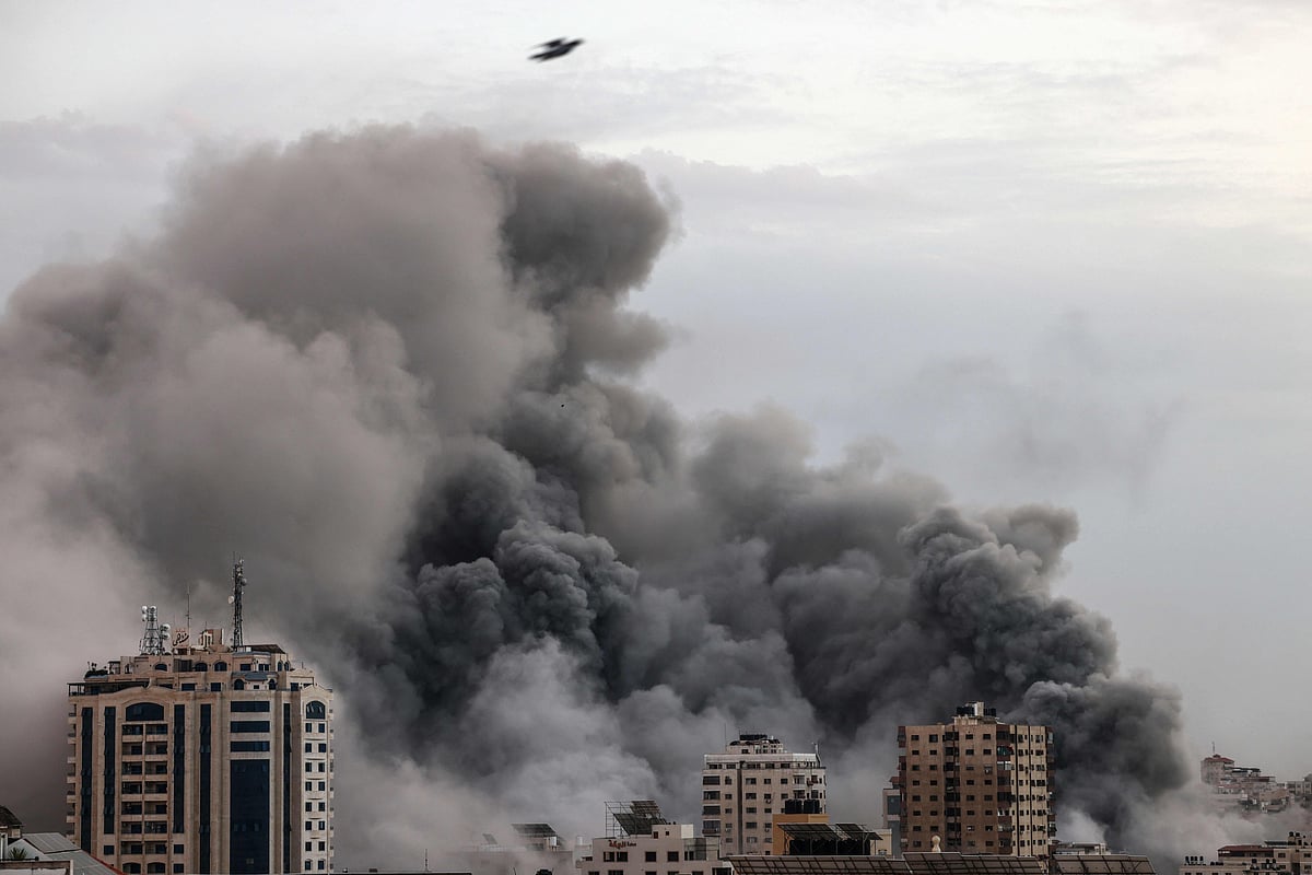 Smoke billows behind highrise buildings during an Israeli airstrike on Gaza City on 9 October, 2023