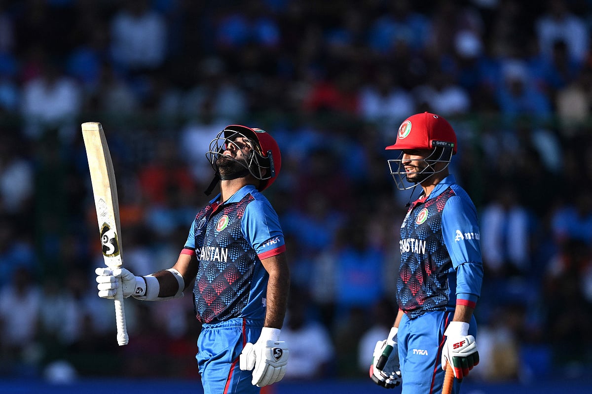 fghanistan's captain Hashmatullah Shahidi (L) celebrates after scoring a half-century (50 runs) as his teammate Azmatullah Omarzai watches during the 2023 ICC Men's Cricket World Cup one-day international (ODI) match between India and Afghanistan at the Arun Jaitley Stadium in New Delhi on October 11, 2023