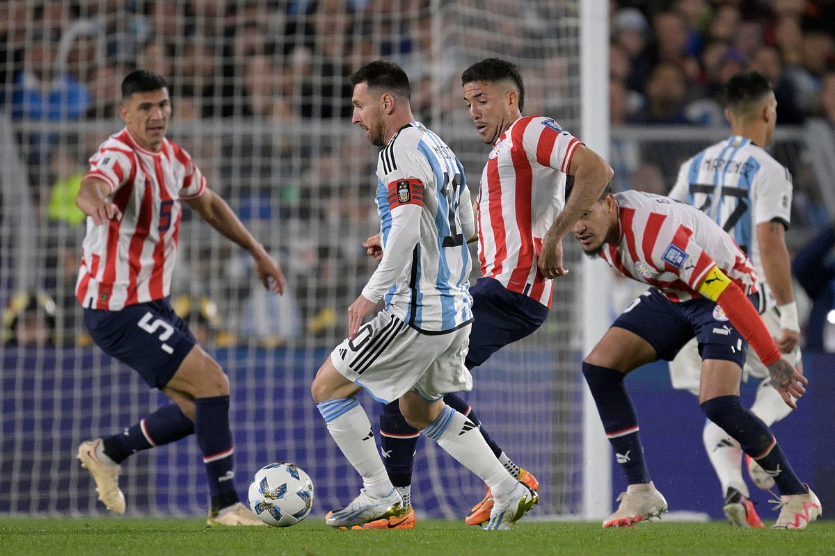 Argentina's forward Lionel Messi and Paraguay's midfielder Alvaro Campuzano fight for the ball during the 2026 FIFA World Cup South American qualification football match between Argentina and Paraguay at the Mas Monumental stadium in Buenos Aires, on 12 October, 2023