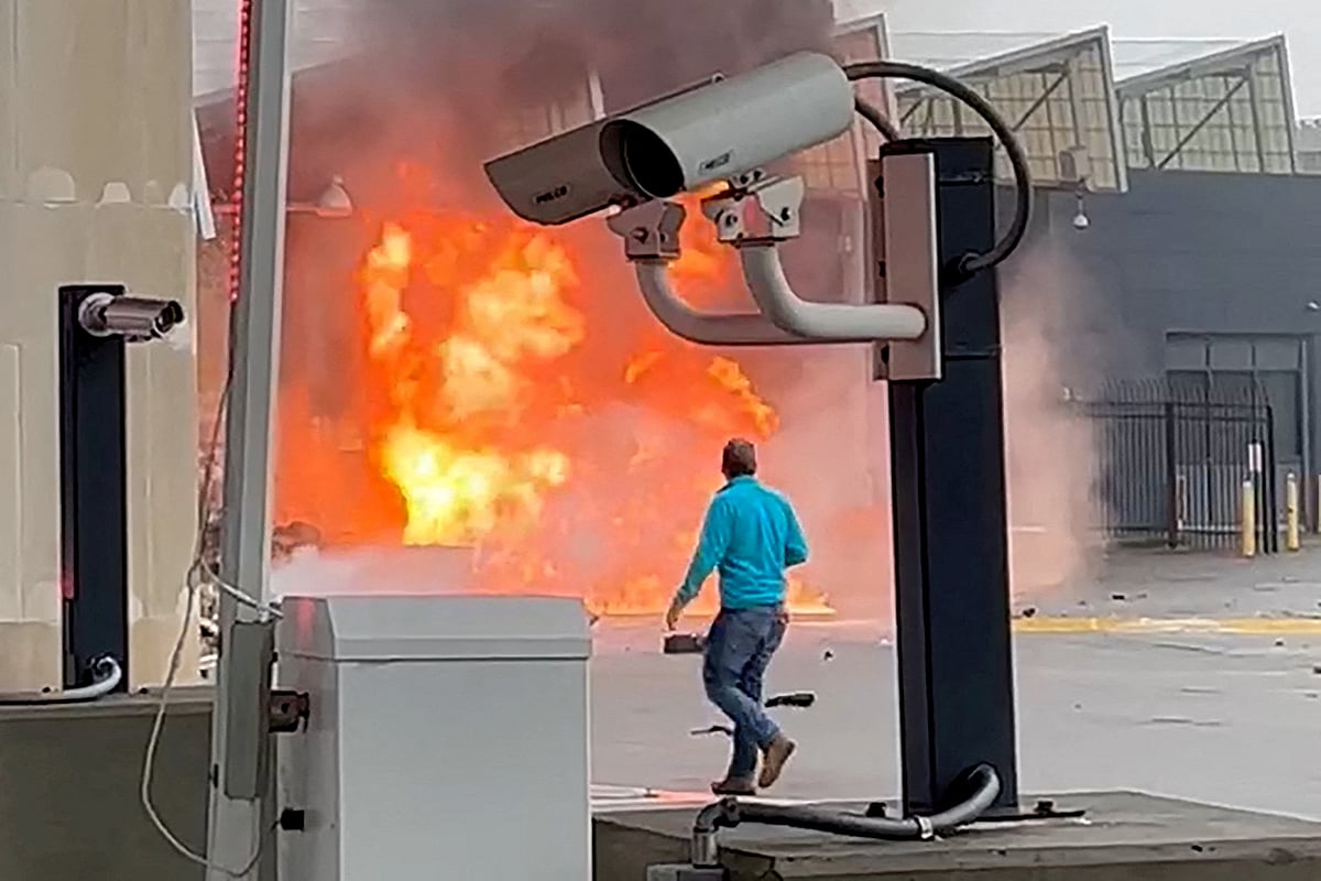 A vehicle burns at the Rainbow Bridge US border crossing with Canada, in Niagara Falls, New York, US November 22, 2023 in a still image from video