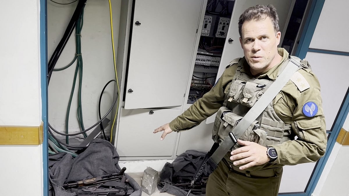 An Israeli officer points at what he describes as weapons discovered at the Al Shifa hospital complex, amid the Israeli military's ground operation against Palestinian Islamist group Hamas, in Gaza City, November 15, 2023 in this still image taken from video
