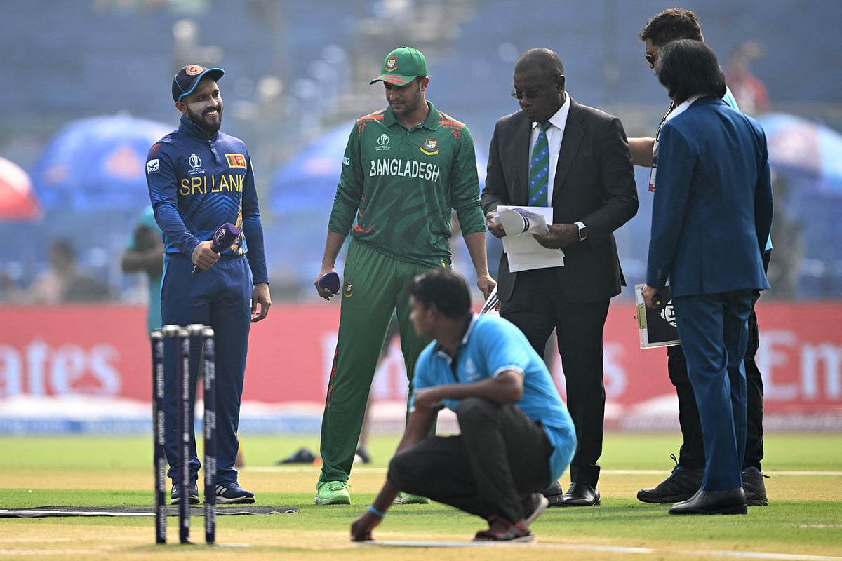 Sri Lanka's captain Kusal Mendis (L) and his Bangladesh counterpart Shakib Al Hasan (2L) gesture during the toss before the start of the 2023 ICC Men's Cricket World Cup one-day international (ODI) match between Bangladesh and Sri Lanka at the Arun Jaitley Stadium in New Delhi on November 6, 2023
