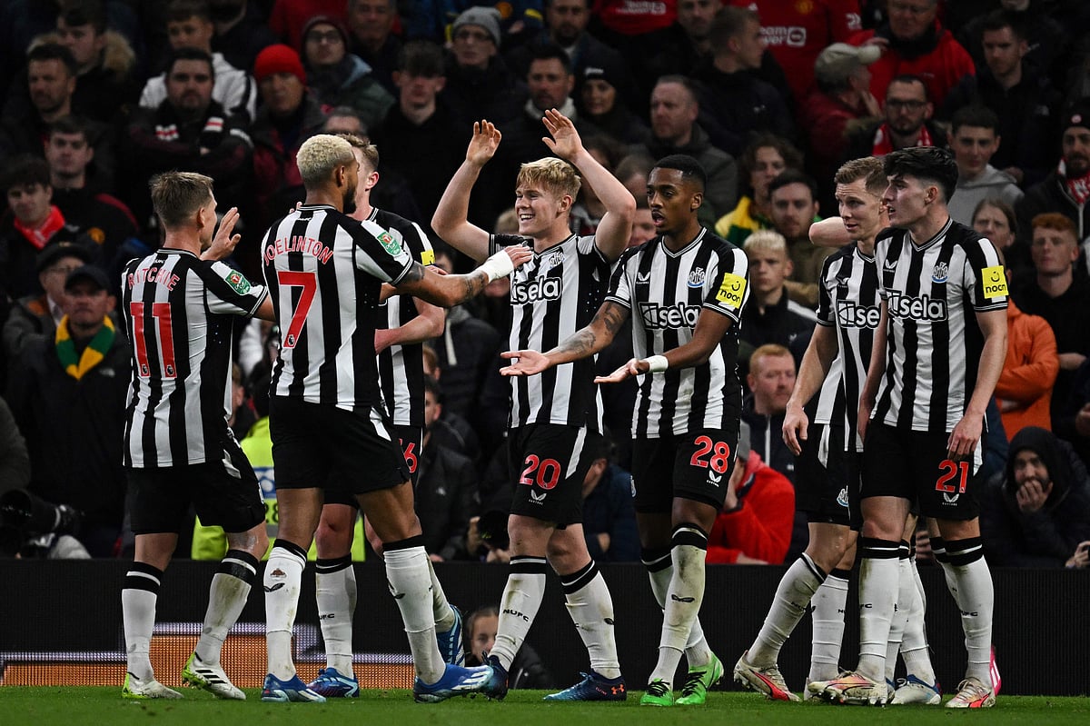 Newcastle United's English midfielder Lewis Hall celebrates with teammates after scoring his team second goal during the English League Cup fourth round football match between Manchester United and Newcastle United at Old Trafford, in Manchester, north west England, on November 1, 202