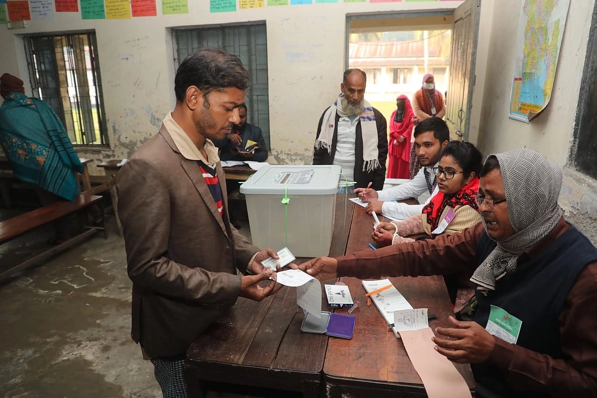 A man prepares to cast a vote at Gopalpur High School polling centre in Dasar Upazila, Madaripur as balloting to the 12th Jatiya Sangsad (JS) elections begins at 8:00am Sunday, 7 January 2024.