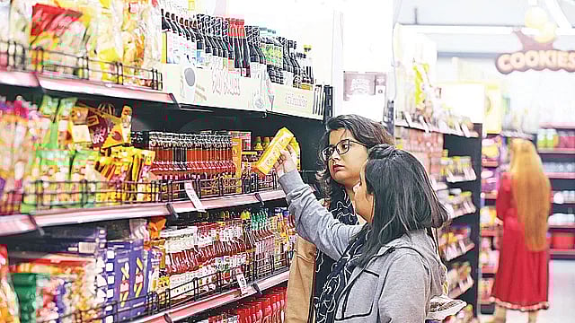 People purchasing from a super shop outlet in the capital's Shyamoli area on Friday