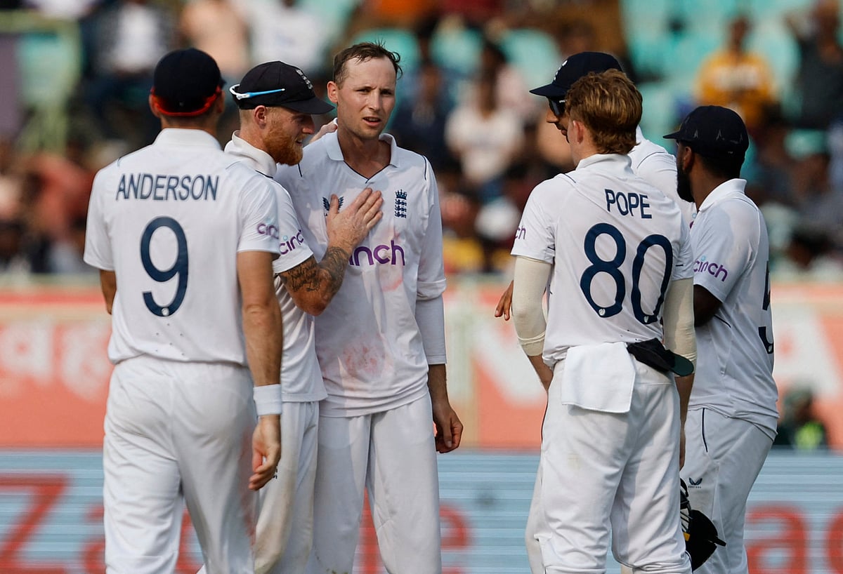 England's Tom Hartley celebrates with teammates after taking the wicket of India's Jasprit Bumrah, caught out by Jonny Bairstow