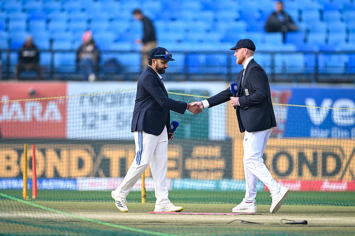 India's captain Rohit Sharma and his England's counterpart Ben Stokes (R) shake hands during the toss before the start of the fifth Test cricket match between India and England at the Himachal Pradesh Cricket Association Stadium in Dharamsala on 7 March, 2024