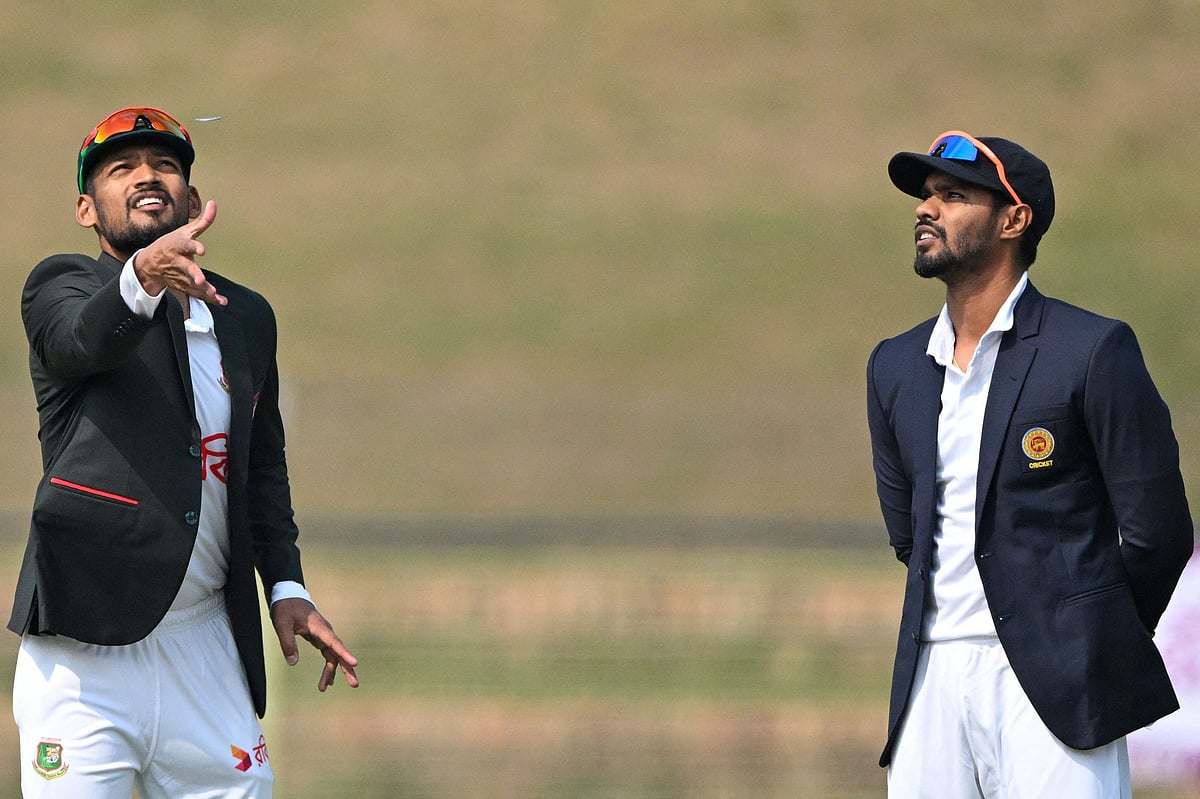 Bangladesh’s captain Najmul Hossain Shanto (L) tosses the coin on the first day of the first Test cricket match between Bangladesh and Sri Lanka at the Sylhet International Cricket Stadium in Sylhet on 22 March, 2024