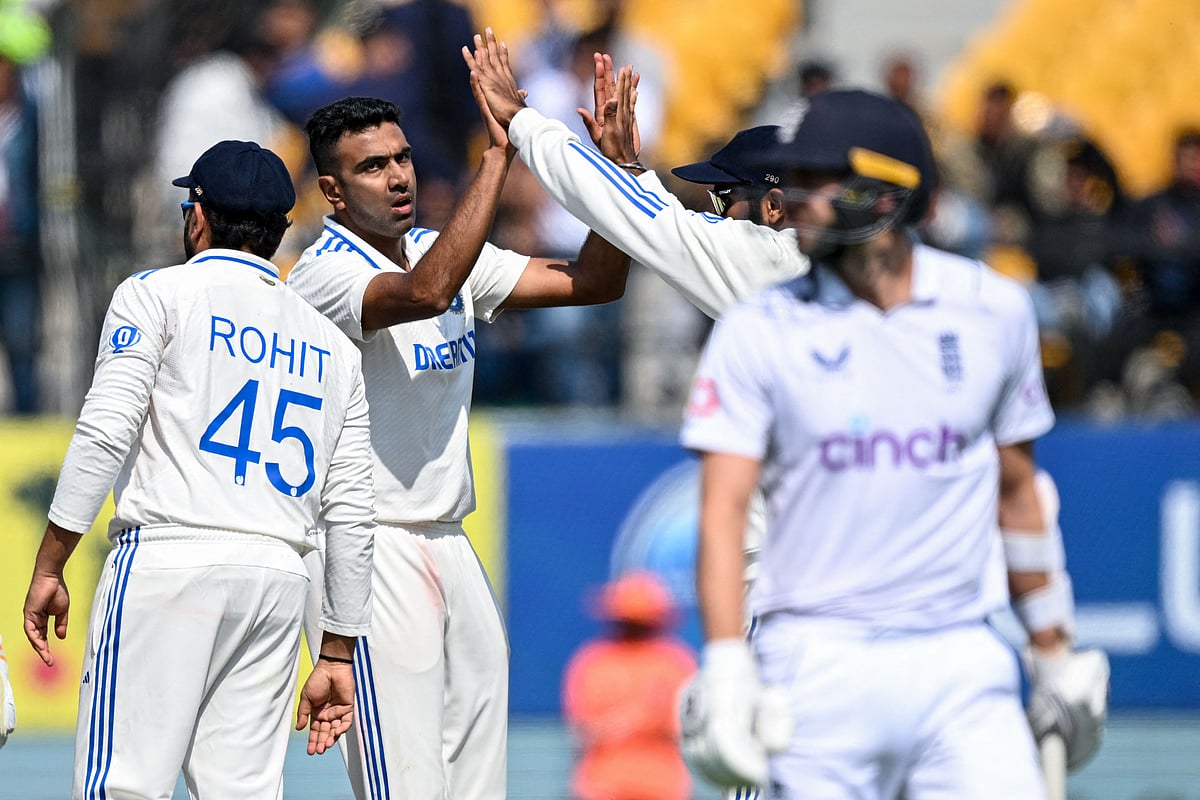 India's Ravichandran Ashwin (2L) celebrates with teammates after taking the wicket of England's Mark Wood (R) during the first day of the fifth and last Test cricket match between India and England at the Himachal Pradesh Cricket Association Stadium in Dharamsala on March 7, 2024