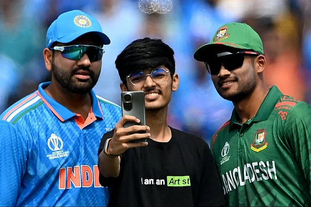 A fan takes a selfie with Bangladesh captain Najmul Hossain and India captain Rohit Sharma during the last World Cup in India.