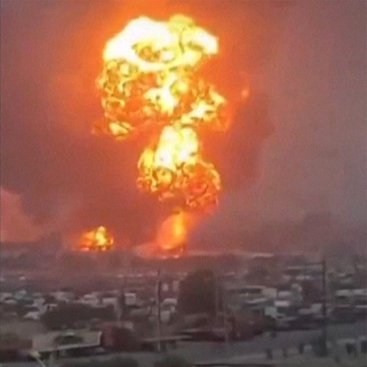 An image grab taken from a UGC video posted on social media on September 29, 2024, shows smoke billowing above Yemen's rebel-held Hodeida port city following Israeli strikes