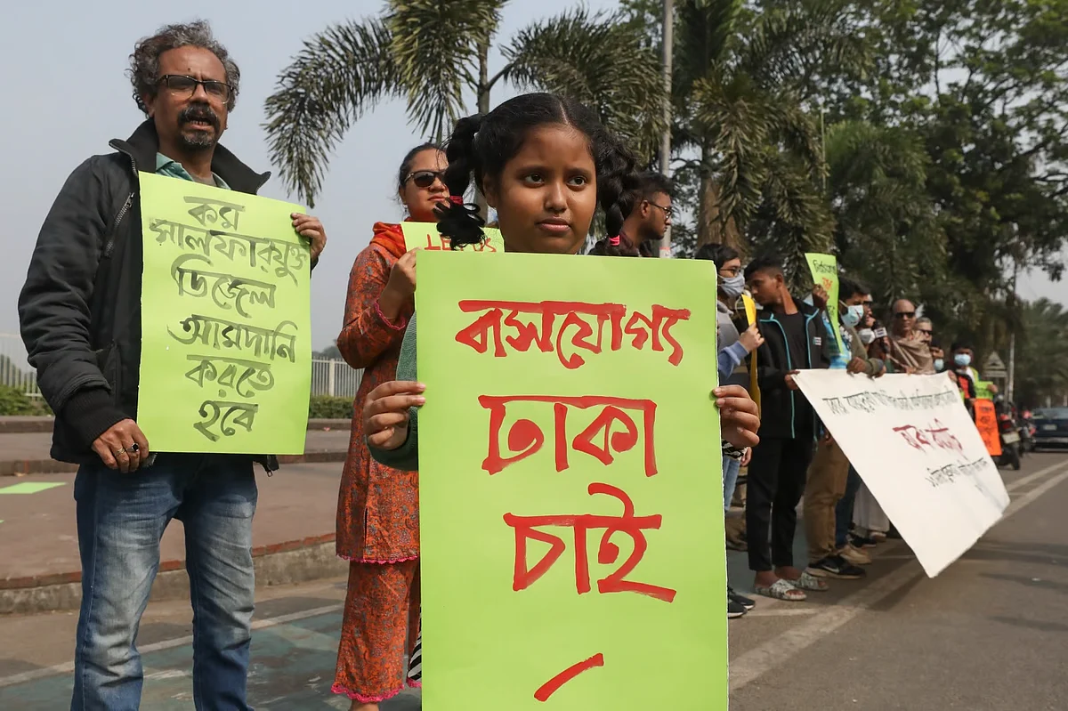 Environment and rights activists, as well children participate in a sit-in programme organised by Janovassyo and earki in front of the Parliament Complex in Dhaka on 13 December 2024, demanding the formulation of an action plan immediately to prevent air pollution in the capital. 