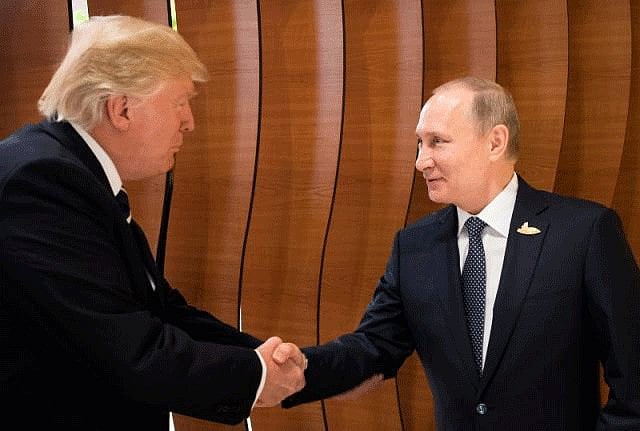 US president Donald Trump and Russian president Vladimir Putin shake hands during the G20 Summit in Hamburg. Photo: Reuters