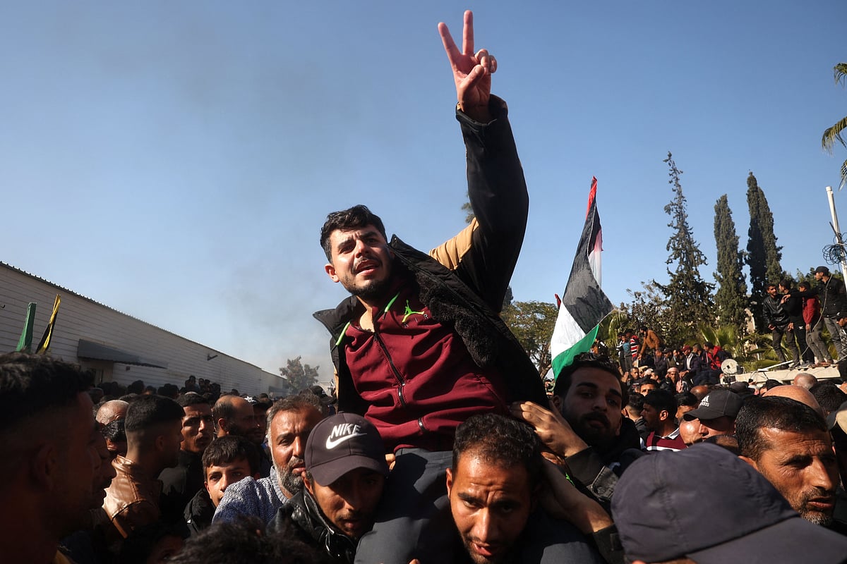 A former Palestinian prisoner, released as part of the sixth hostage-prisoner exchange, flashes the V for victory sign as he is welcomed by friends and relatives upon arriving at the European Hospital in Khan Yunis in the southern Gaza Strip on 15 February, 2025.
