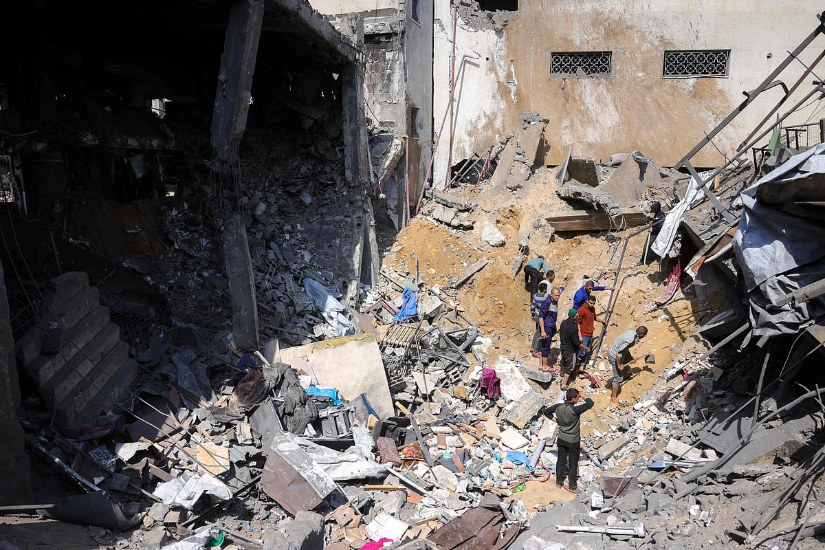 People look for survivors in the rubble of a building destroyed in an Israeli strike in Jabalia, in the northern Gaza Strip on 18 March 2025