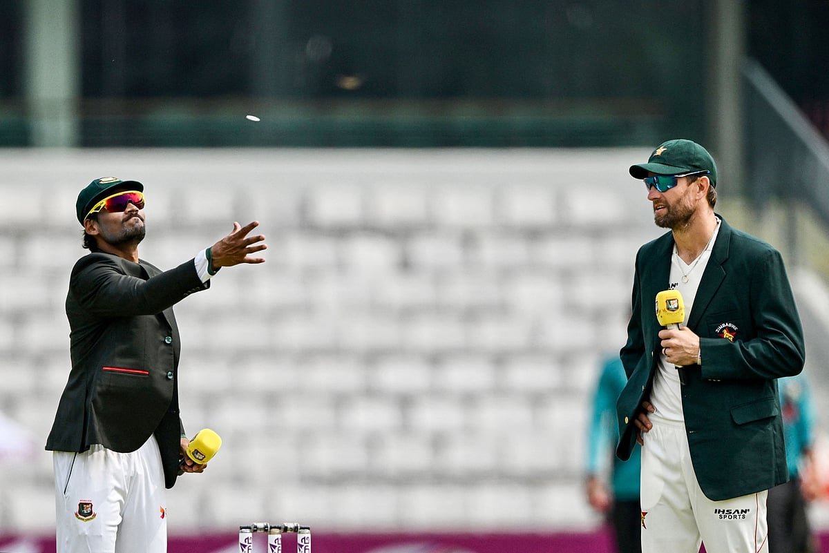 Bangladesh captain Najmul Hossain Shanto (L) tosses the coin alongside his Zimbabwe counterpart Craig Ervine before the start of play on the first day of the first Test cricket match between Bangladesh and Zimbabwe at the Sylhet International Cricket Stadium in Sylhet on 20 April, 2025.