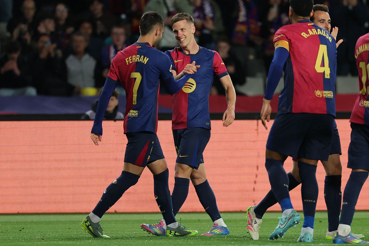 Barcelona’s Spanish forward #20 Daniel Olmo (2L) celebrates with teammates after scoring his team’s first goal during the Spanish league football match between FC Barcelona and RCD Mallorca at the Estadi Olimpic Lluis Companys in Barcelona, on 22 April 2025