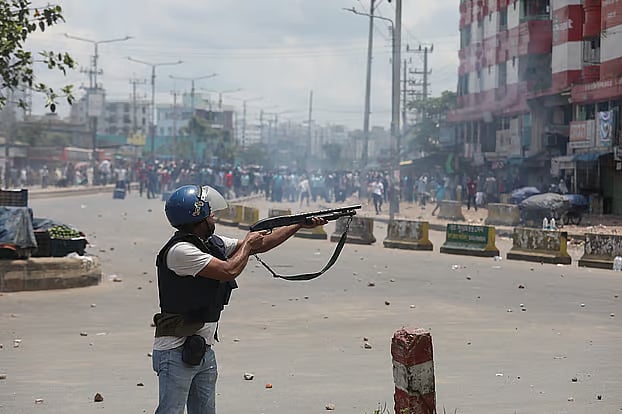 A policeman opens fires at the protesters during the quota reform movement in Chattogram.