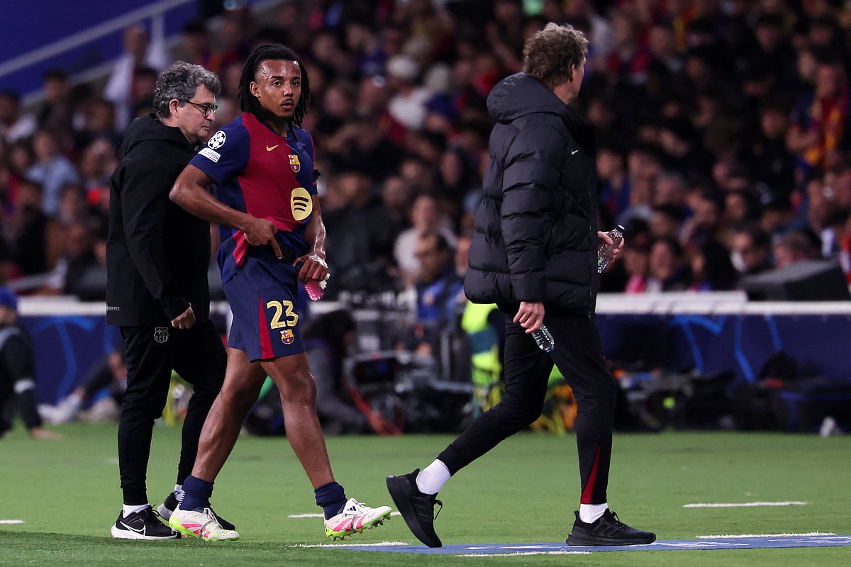 Barcelona's French defender #23 Jules Kounde leaves the pitch after resulting injured during the UEFA Champions League semi final first leg football match between FC Barcelona and Inter Milan at the Estadi Olimpic Lluis Companys in Barcelona on 30 April, 2025