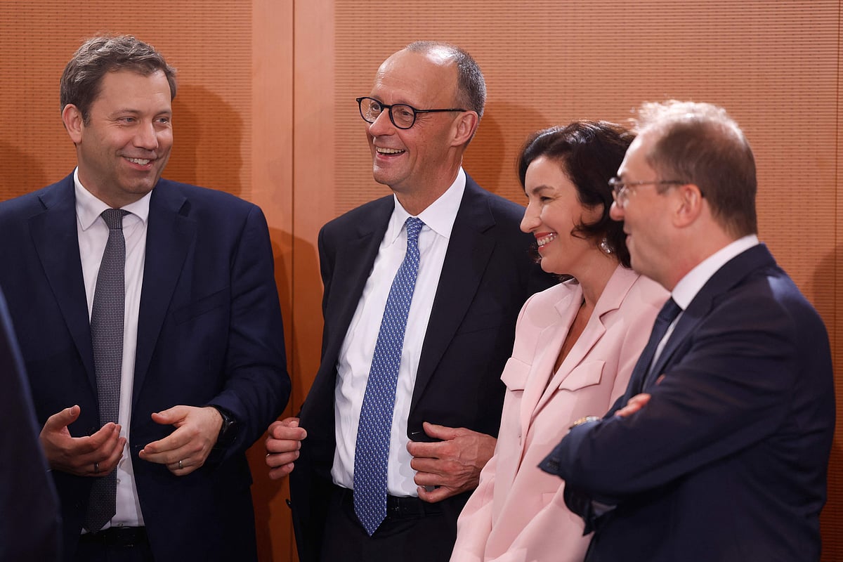 German Chancellor Friedrich Merz (2ndL) laughs with German Finance Minister and Vice Chancellor Lars Klingbeil (L), German Minister for Research, Technology and Space Dorothee Baer (2ndR) and German Interior Minister Alexander Dobrindt prior the constituent cabinet meeting of the new government at the Chancellery in Berlin on 6  May 2025