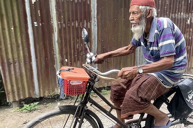 Anwar Hossain is riding a bicycle. Recently in Dhulauri, Singra, Natore