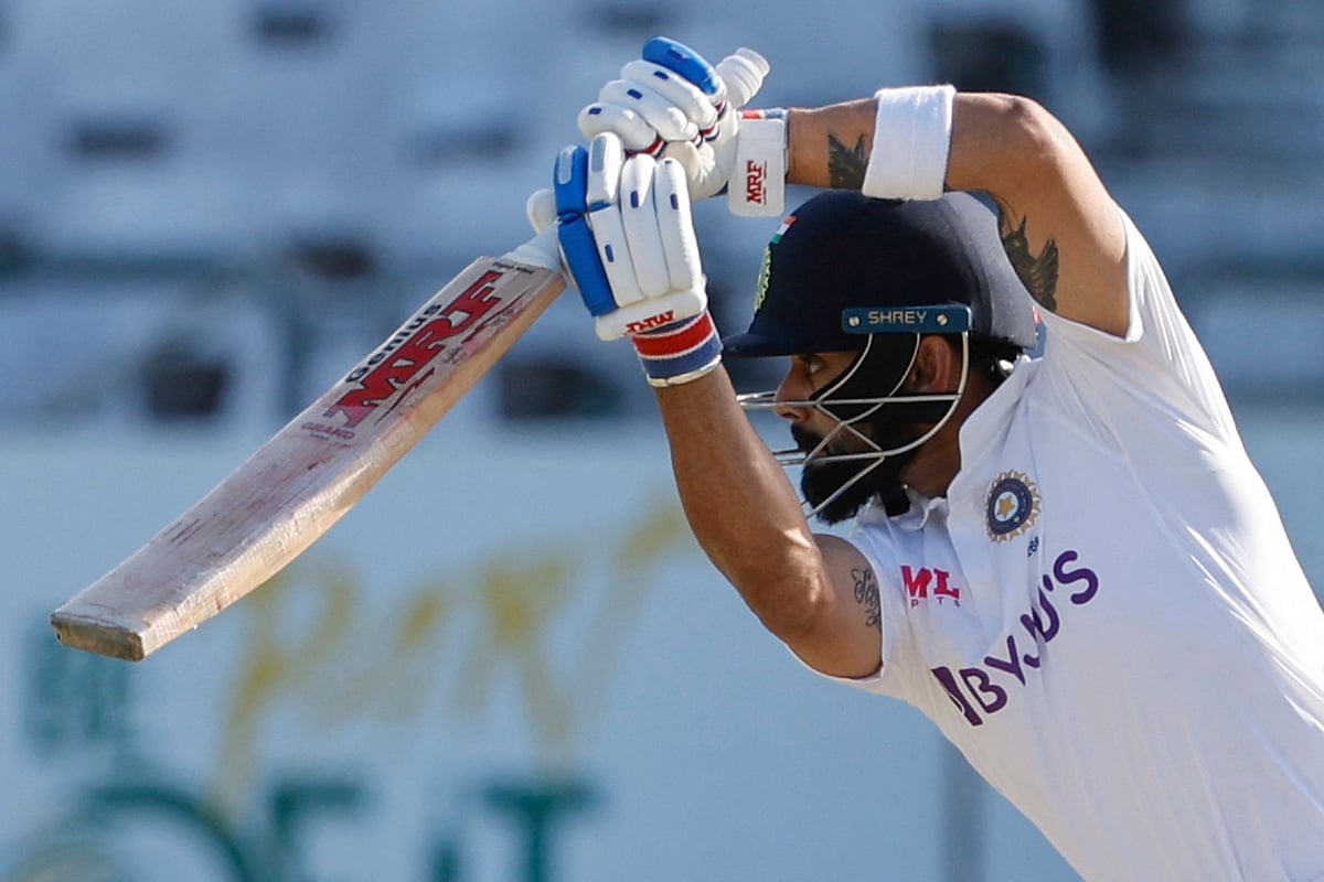 India's Virat Kohli watches the ball after playing a shot during the second day of the third Test cricket match between South Africa and India at Newlands stadium in Cape Town on 12 January 2022.
