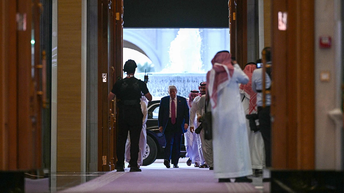 US President Donald Trump (C) and Saudi Crown Prince Mohammed bin Salman arrive for the Saudi-US investment forum at the King Abdul Aziz International Conference Center in Riyadh on 13 May, 2025.