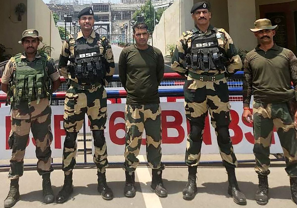 This handout photograph taken on 14 May 2025 and released by the India's Border Security Force (BSF) shows India's BSF soldier Purnam Kumar Shaw (C) after he was handed over to India, at the India-Pakistan Wagah border post, about 35kms from Amritsar.