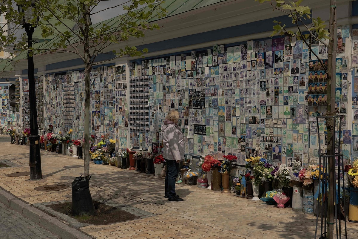 A woman looks at the “The Wall of Remembrance of the Fallen for Ukraine”, a memorial for fallen Ukrainian soldiers, in Kyiv on 14 May 2025, amid the Russian invasion of Ukraine. President Volodymyr Zelensky said Ukraine was ready for “any format” of negotiations to end war with Russia ahead of talks in Istanbul on 15 May 2025, but said his next steps will depend on who represents Russia at the meeting
