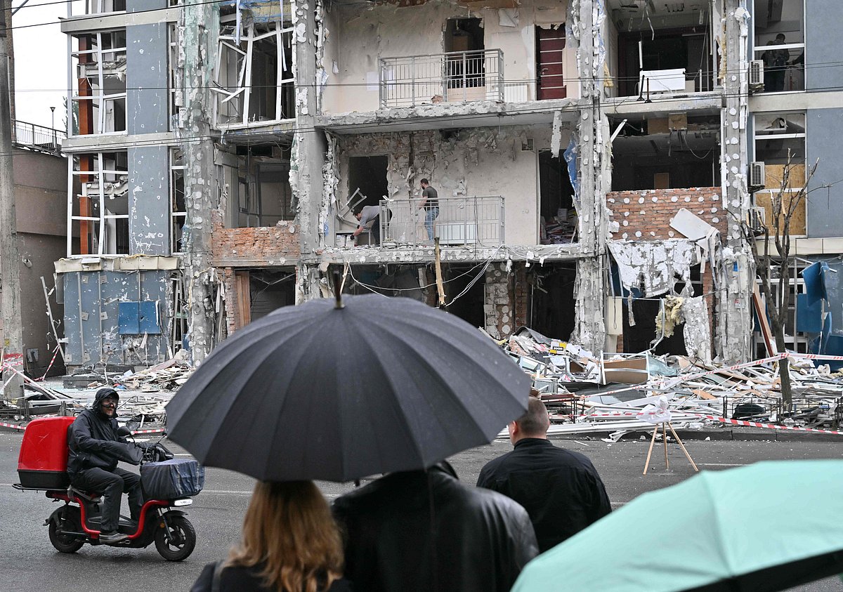 People look at a multistory residential building damaged following a drone strike in Kyiv on May 25, 2025, amid Russian invasion in Ukraine. Russia launched a record number of drones against Ukraine and killed 12 people across the country, officials said on May 25, even as Kyiv and Moscow completed their biggest prisoner exchange since the start of the war.