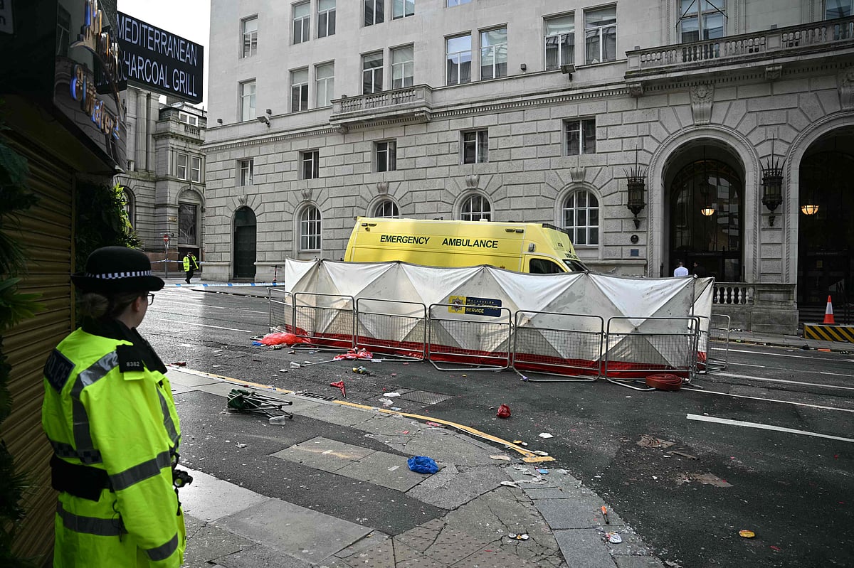 A police officer stands on duty at a cordon leading to Water Street in Liverpool, north-west England on 27 May, 2025, where a car ploughed in to crowds that had gathered to watch an open-top bus victory parade for Liverpool's Premier League trophy parade on 26 May