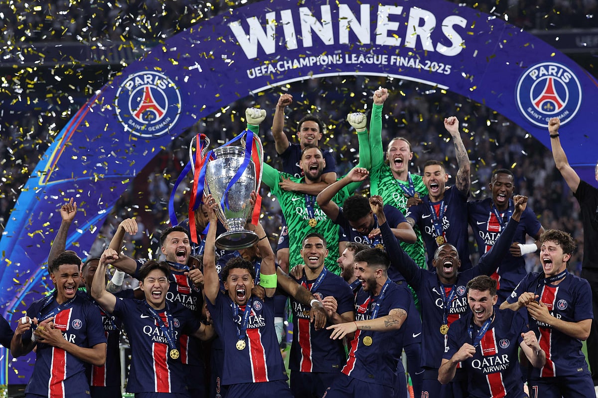 Paris Saint-Germain's Brazilian defender #05 Marquinhos lifts the trophy as he celebrates with teammates winning the UEFA Champions League final football match between Paris Saint-Germain (PSG) and Inter Milan in Munich, southern Germany, on 31 May, 2025.