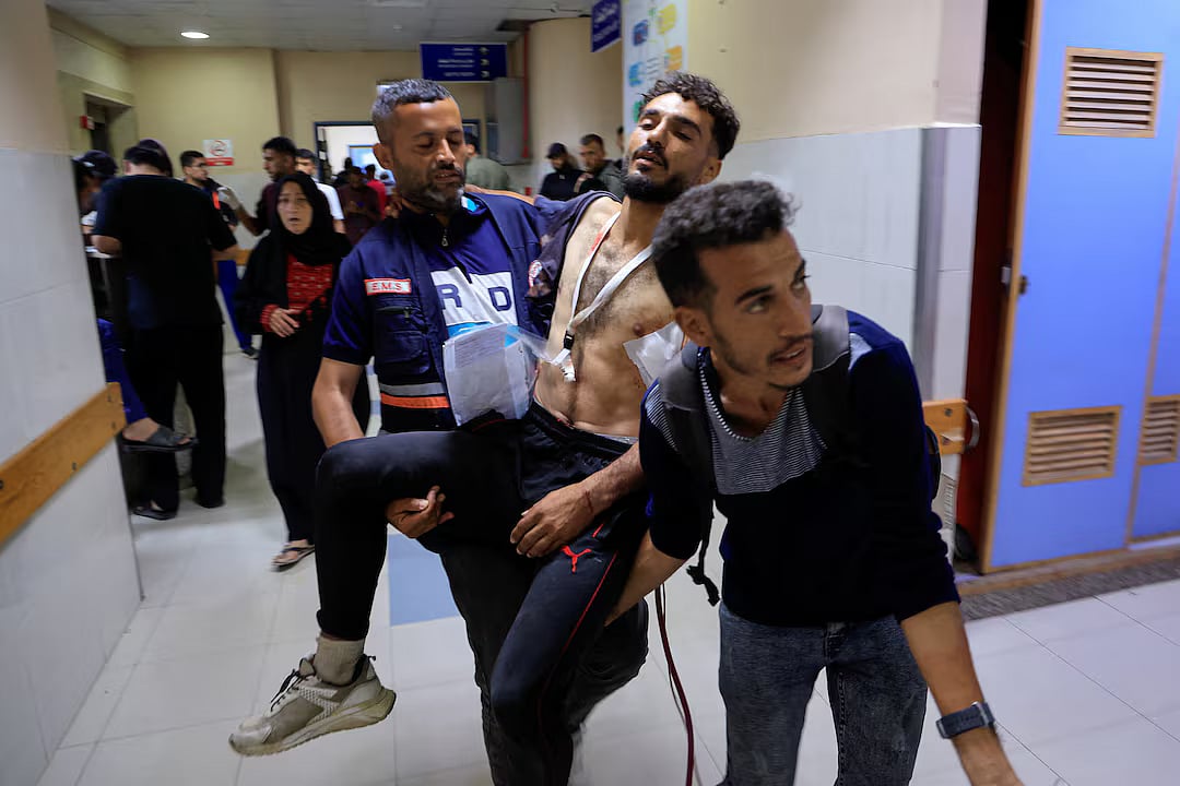 A paramedic carries a Palestinian man wounded in an Israeli strike, at Nasser Hospital, in Khan Younis, in the southern Gaza Strip, 1 June, 2025.