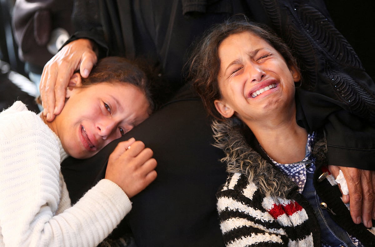 Girls react during the funeral of Palestinians who, according to medics, were killed in Israeli strikes, at Nasser hospital, in Khan Younis, in the southern Gaza Strip, on 2 June 2025