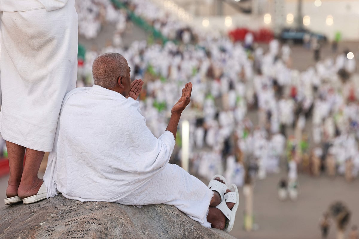 Muslim pilgrims pray at dawn on Saudi Arabia's Mount Arafat, also known as Jabal al-Rahma or Mount of Mercy, during the climax of the Hajj pilgrimage on 5 June, 2025.