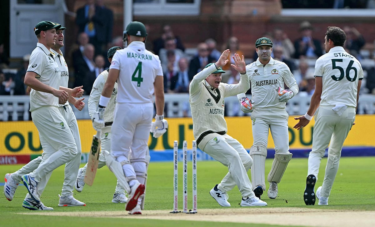 Australia’s Mitchell Starc celebrates with Australia’s Steven Smith (C) after taking the wicket of South Africa’s Aiden Markram during day one of the ICC World Test Championship cricket final match between Australia and South Africa, at Lord’s cricket ground, in London, on 11 June 2025