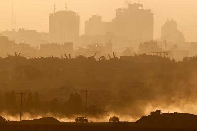 Military vehicles manoeuvre in Gaza, as seen from the Israeli side of the border, 11 June, 2025.