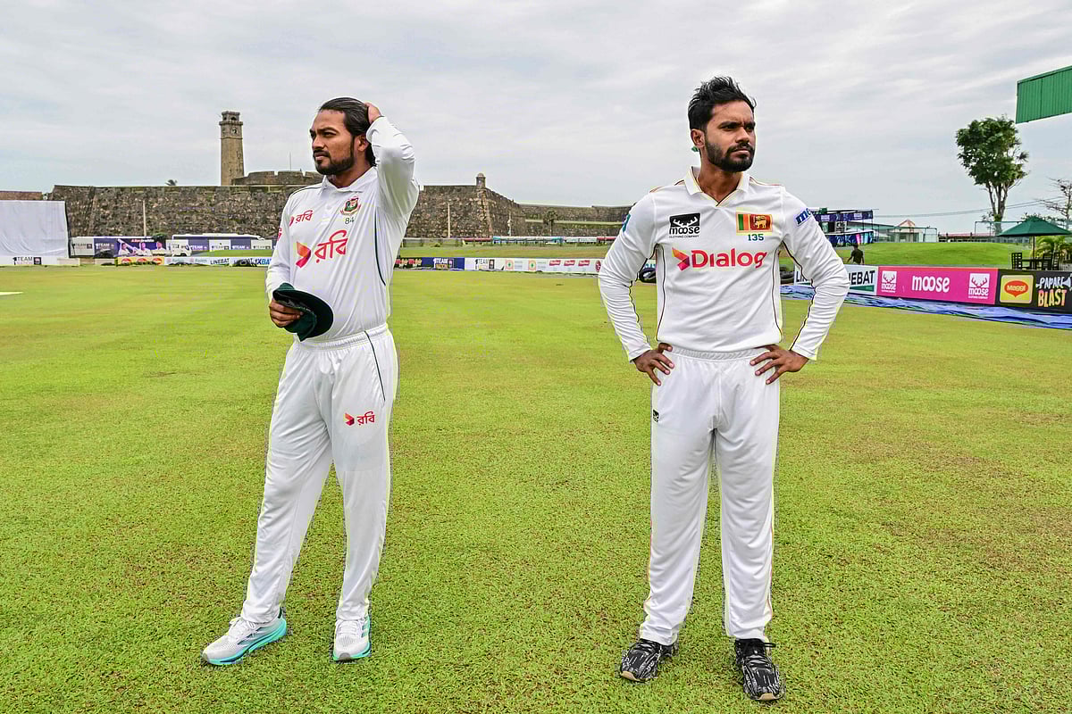 Bangladesh’s captain Najmul Hossain Shanto (L) and his Sri Lanka’s counterpart Dhananjaya de Silva look on during the unveiling of winning trophy on the eve of their first Test cricket match at the Galle International Cricket Stadium in Galle on 16 June 2025
