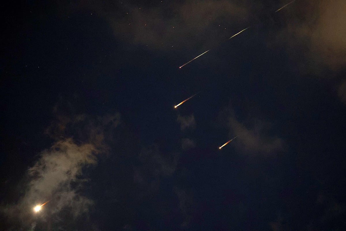 Rocket trails are seen in the sky above the Israeli coastal city of Netanya amid a fresh barrage of Iranian missile attacks on June 17, 2025.