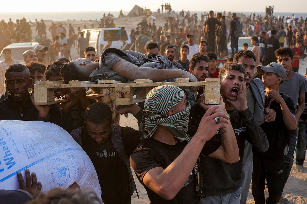 Men carry on a pallet the body of a victim who was reportedly killed by Israeli bombardment in western Jabalia in the northern Gaza Strip on 17 June 2025 amid the ongoing war between Israel and Hamas.