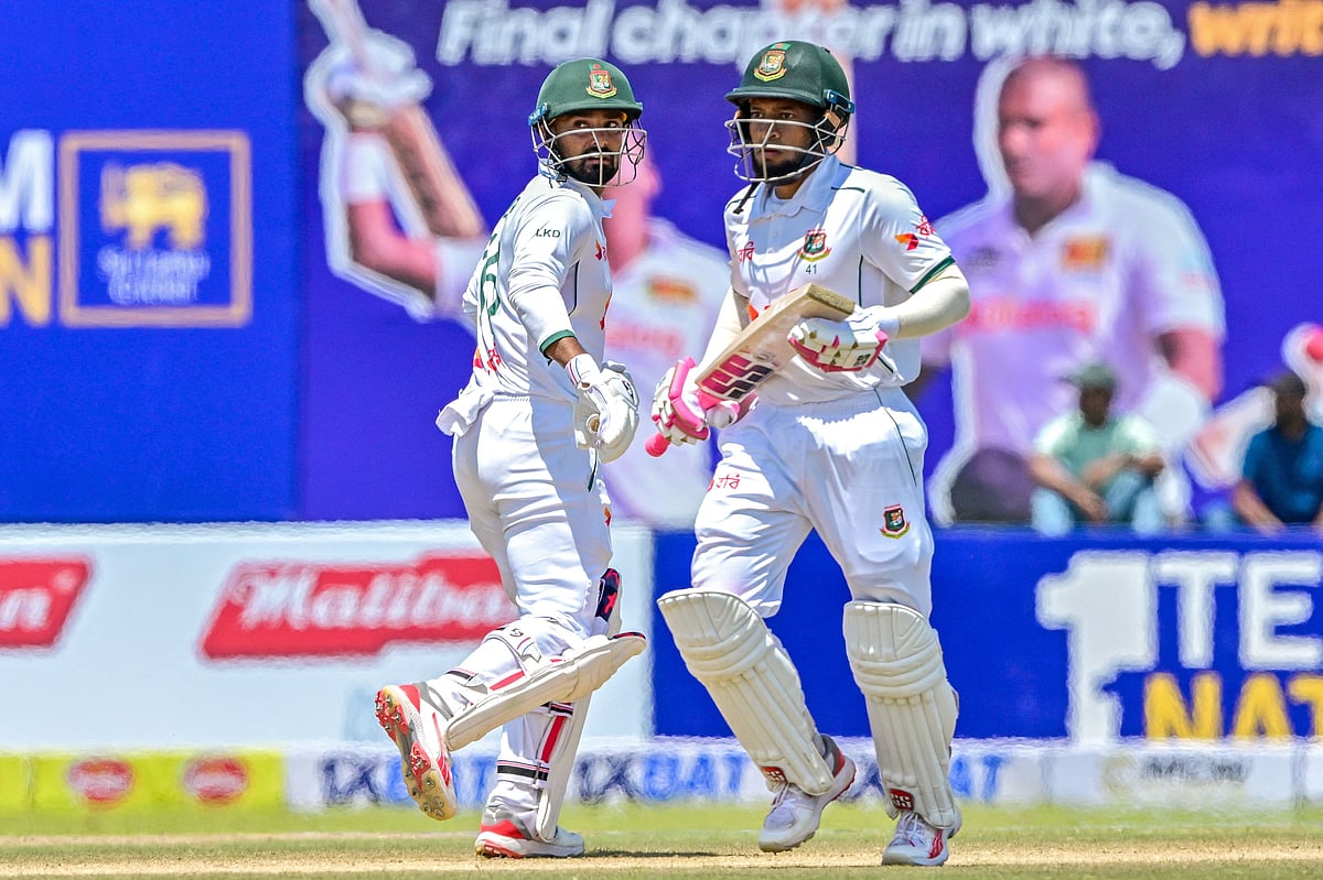 Mushfiqur Rahim (R) and Litton Das run between the wickets during the second day of the first Test cricket match between Sri Lanka and Bangladesh at the Galle International Cricket Stadium in Galle on 18 June 2025