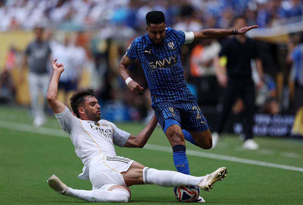 Salem Aldawsari #29 of Al Hilal is tackled by Raul Asencio #35 of Real Madrid C.F. during the FIFA Club World Cup 2025 group H match between Real Madrid CF and Al Hilal at Hard Rock Stadium on 18 June 2025 in Miami Gardens, Florida
