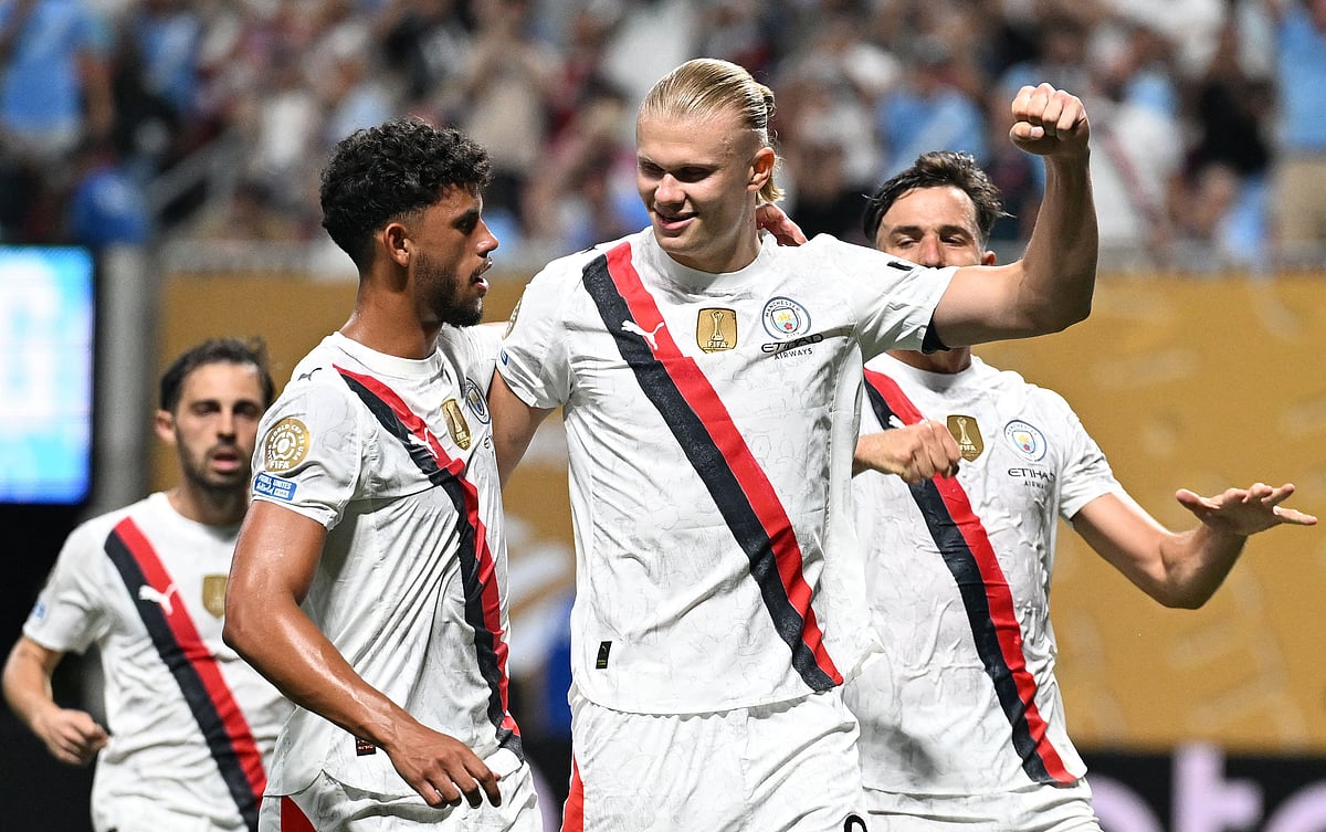 Manchester City's Norwegian striker #09 Erling Haaland (R) celebrates with teammate Portuguese midfielder #27 Matheus Nunes after scoring his team's third goal during the FIFA Club World Cup 2025 Group G football match between England's Manchester City and UAE's Al Ain FC at the Mercedes-Benz stadium in Atlanta on 22 June, 2025.