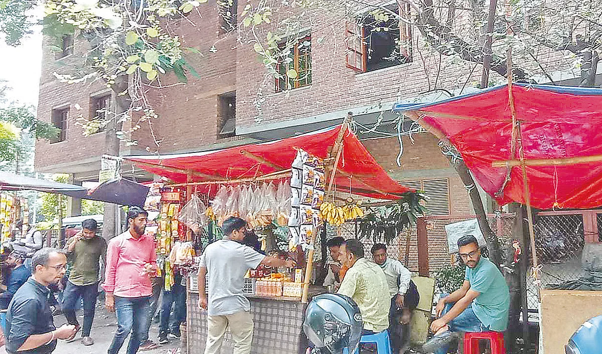 Cigarette stalls are seen set up occupying footpath near the Chhayanaut Bhaban at Dhanmondi-15, Dhaka