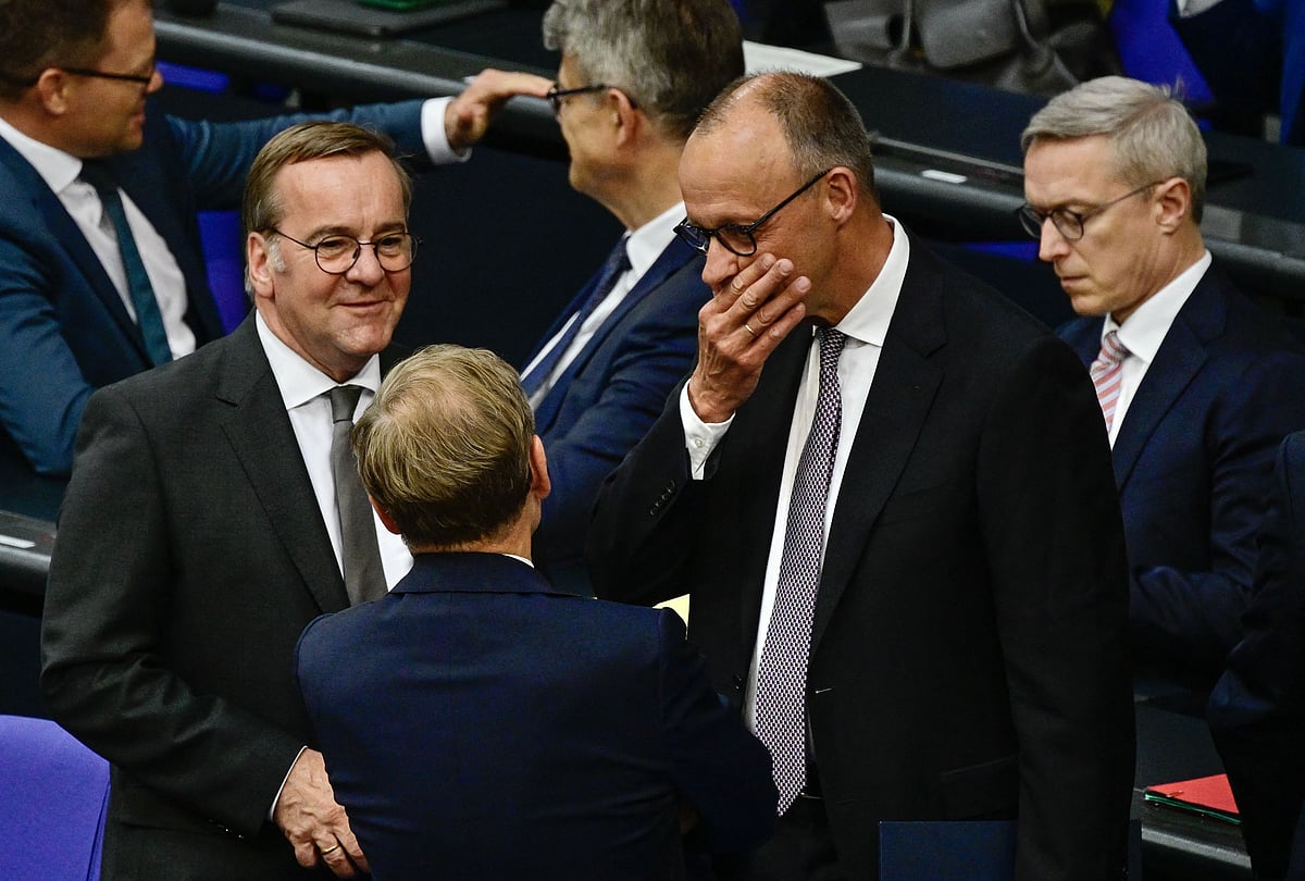 German Chancellor Friedrich Merz (2ndR) talks with German Defence Minister Boris Pistorius (L) and German Foreign Minister Johann Wadephul (C) before addressing delegates at the Bundestag (lower house of parliament), on 24 June 2025 in Berlin, prior on the upcoming NATO and EU summits.