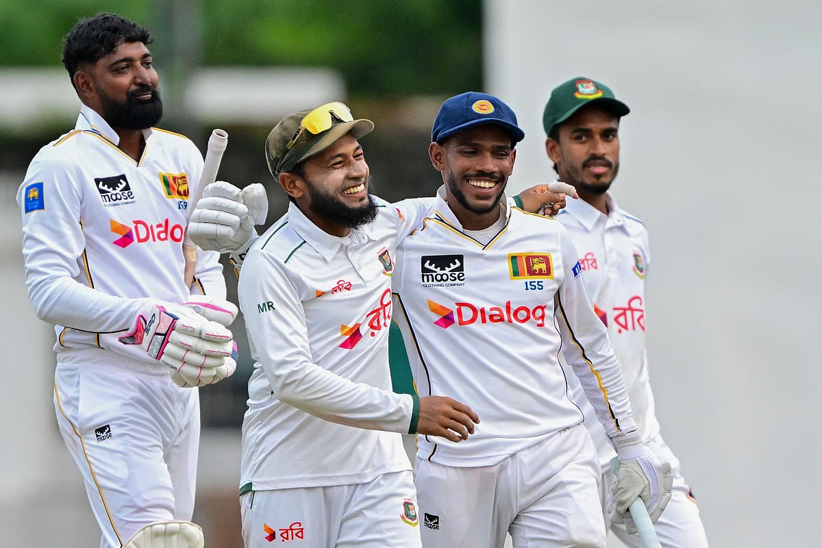 Bangladesh's Mushfiqur Rahim (2L) and Sri Lanka's Pathum Nissanka (2R) share a light moment as they walk back to the pavilion at the end of play on the second day of the second Test cricket match between Sri Lanka and Bangladesh at the Sinhalese Sports Club (SSC) Ground in Colombo on 26 June, 2025.